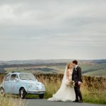 Just married couple with Fiat 500 wedding car in the Yorkshire moors